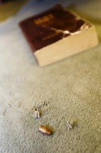 A bullet pastor Earl Carswell dug out of the church’s carpet rests next to a Bible. 